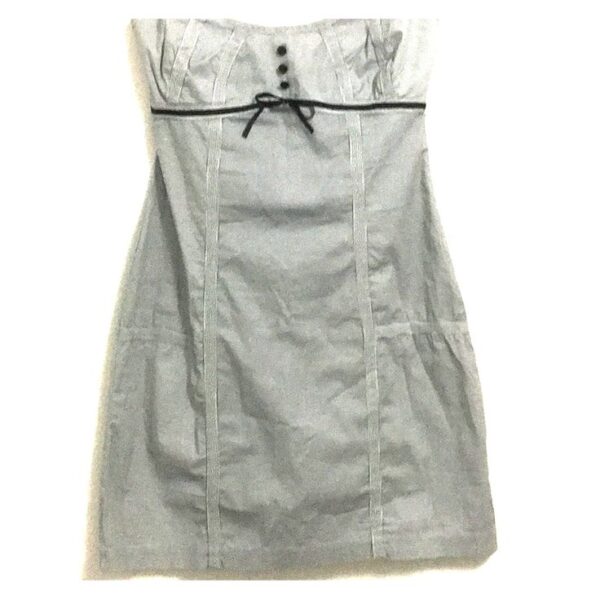white strapless dress decorated with blue buttons and ribbon