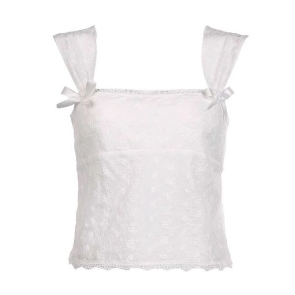 Cropped white blouse with short sleeves, decorated with lace and bows.